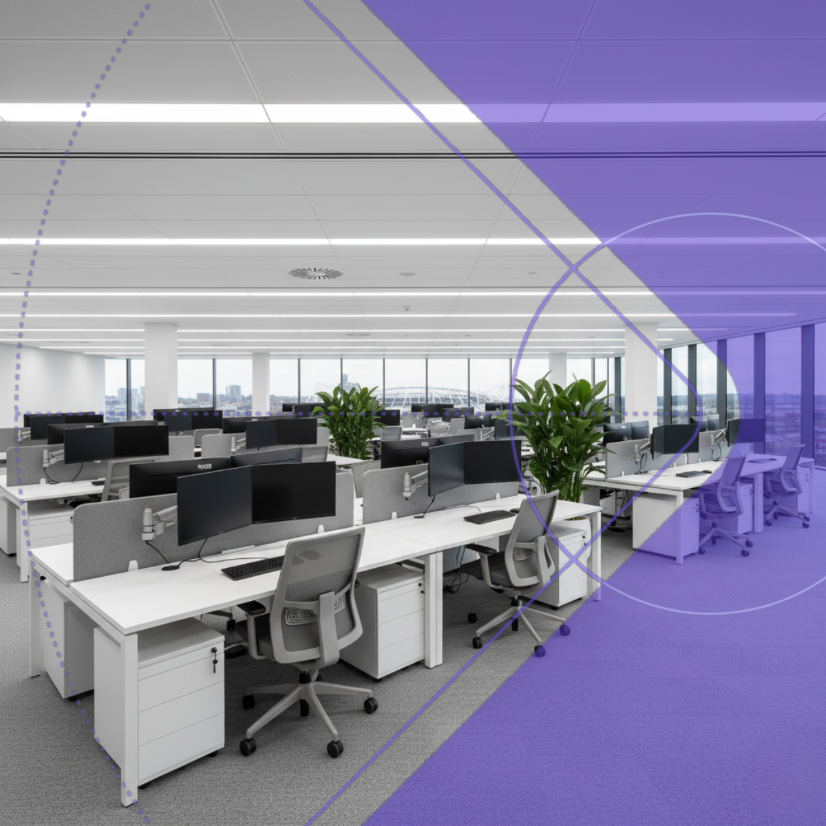 Modern office with desks, chairs, and large windows.